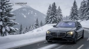 Luxury black Mercedes S-Class 2025 navigating a winding, snow-covered alpine road during a comfortable Geneva to Avoriaz transfer in winter.