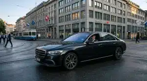 Limogroup black Mercedes-Benz S-Class driving in the financial district of Zurich for a corporate roadshow.