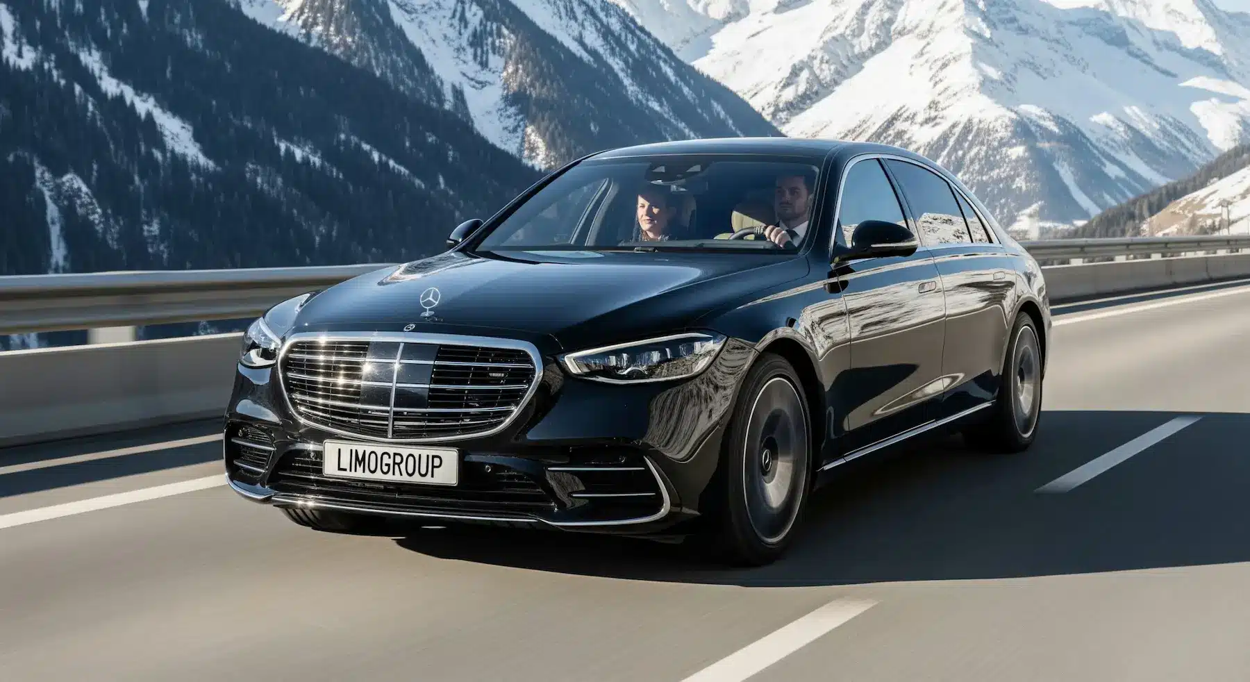Geneva to Chamonix transfer, black Mercedes S-Class on an alpine highway with mountain views.