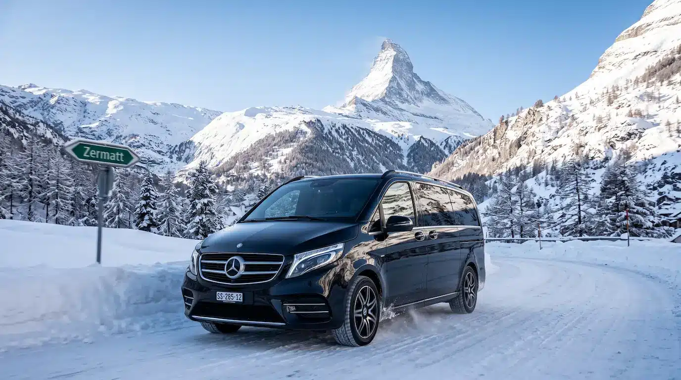 Limogroup Mercedes V-Class driving on a snowy alpine road for a direct private transfer to Zermatt.